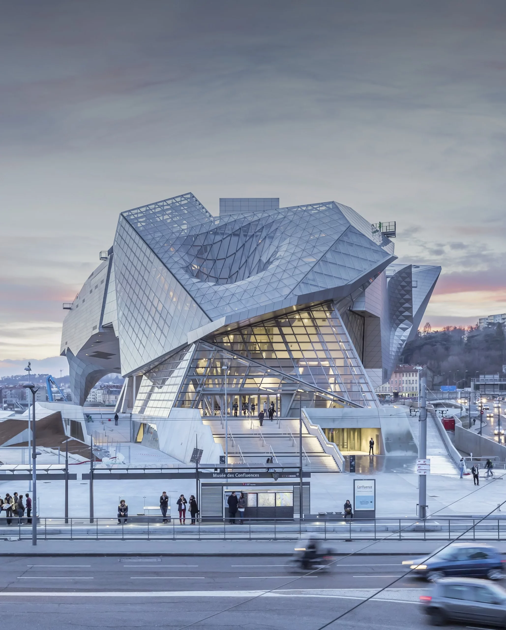 The Musée des Confluences in Lyon, its geometric steel and glass façade engineered by Permasteelisa Group, photographed at dusk